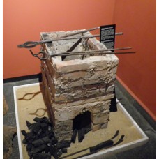 Rectangular grill, clay bricks with metal tongs, and coals